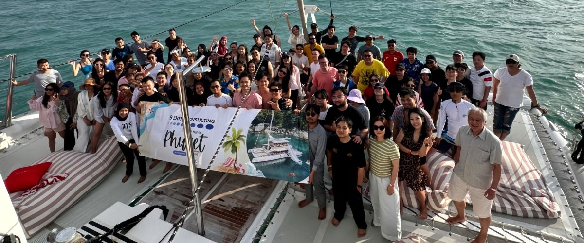 9 Dots Consulting team group photo aboard a boat during the 2025 company trip in Phuket, Thailand