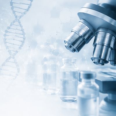 Laboratory microscope with medical and life sciences research equipment.